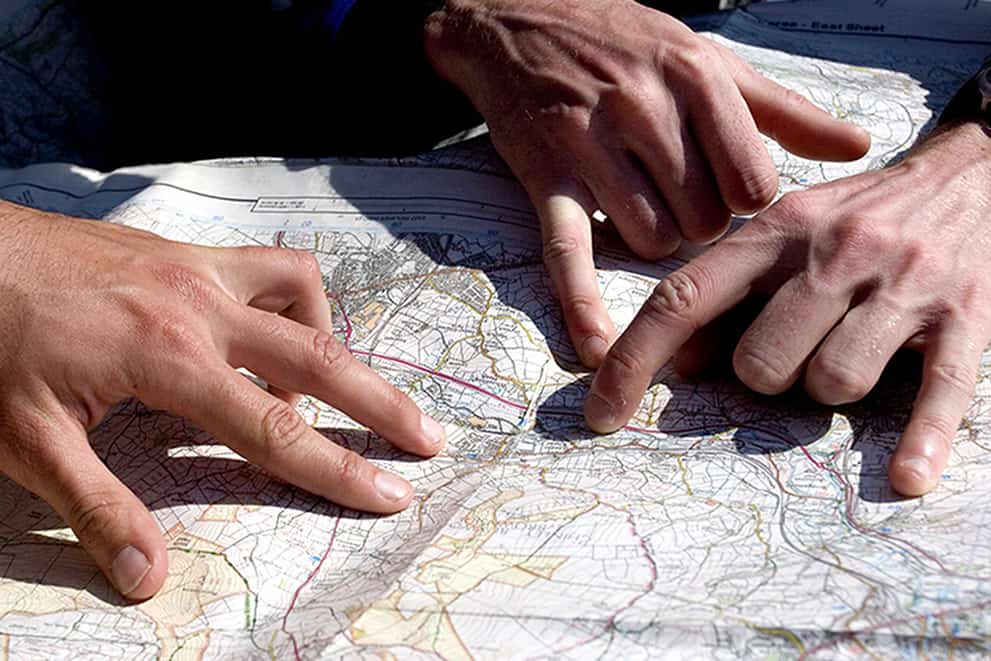 Sets of hands on a map whilst learning to navigate