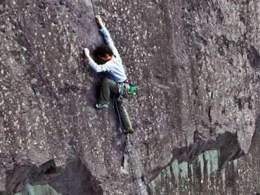 A man rock climbing in the Peak District