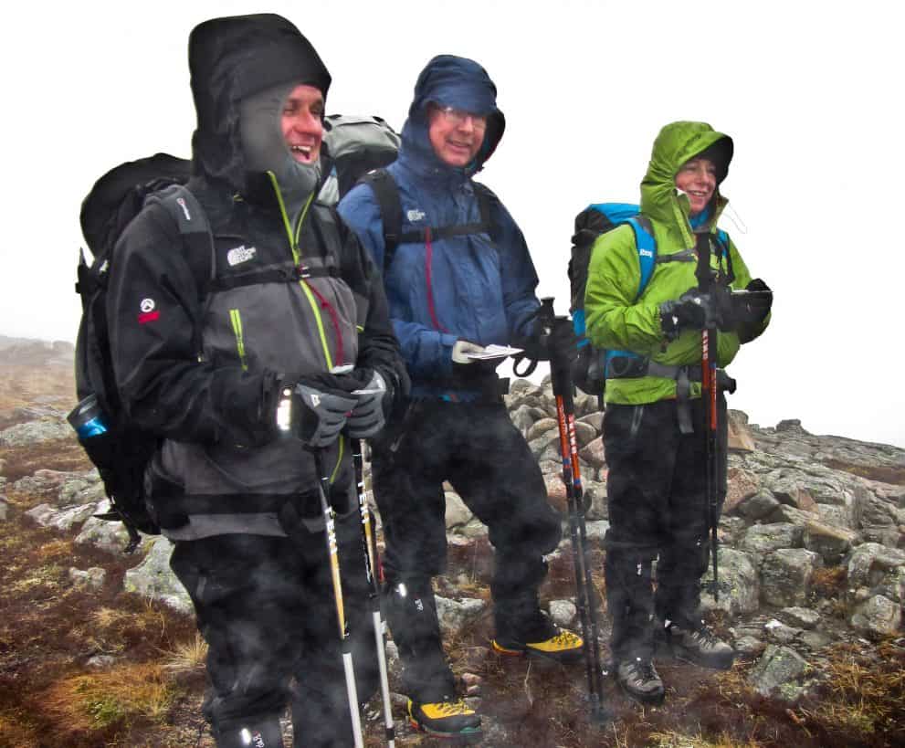3 men stood on a mountain