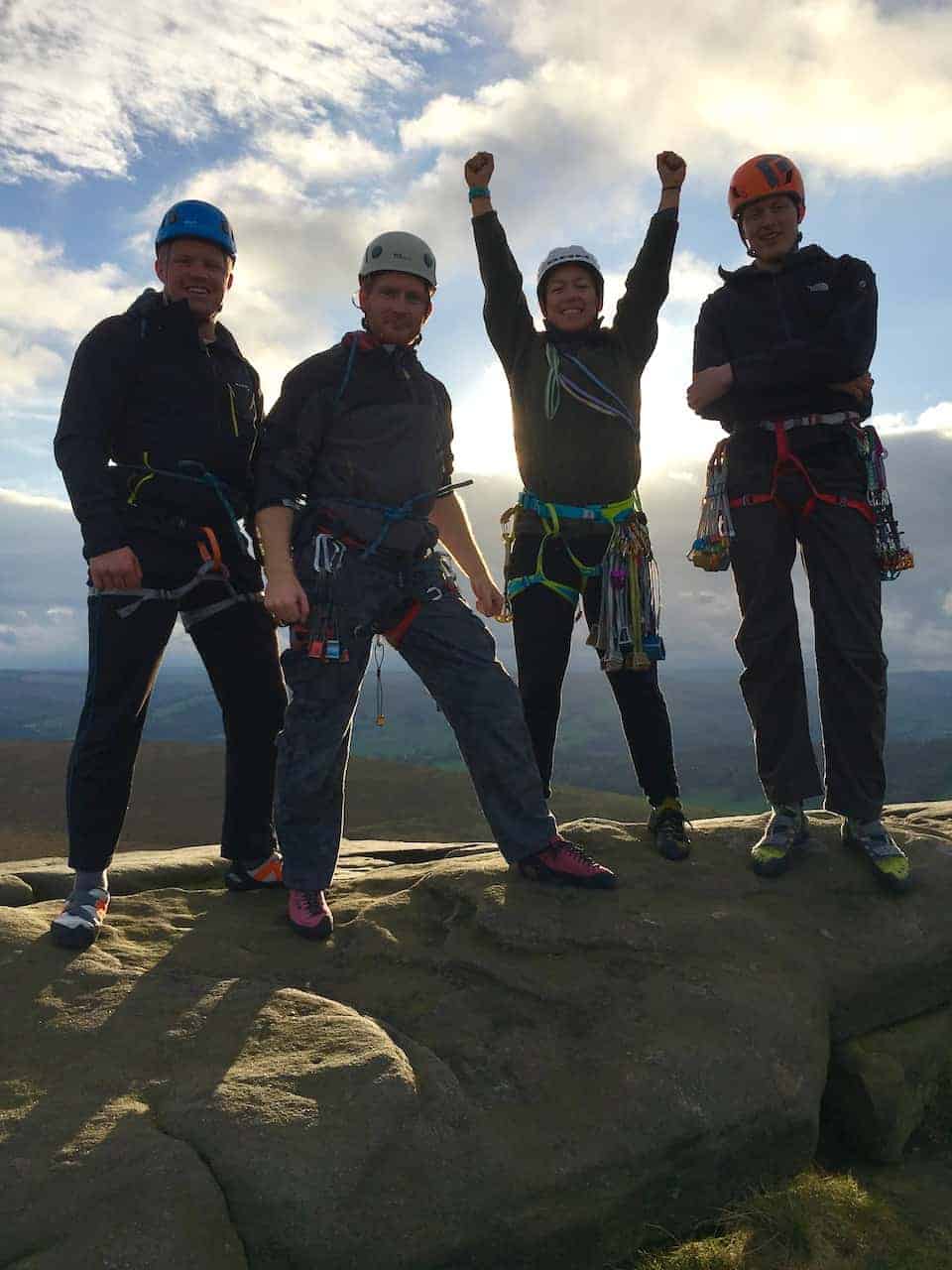 Four people at the top of a rock climb equals Peak District team building success
