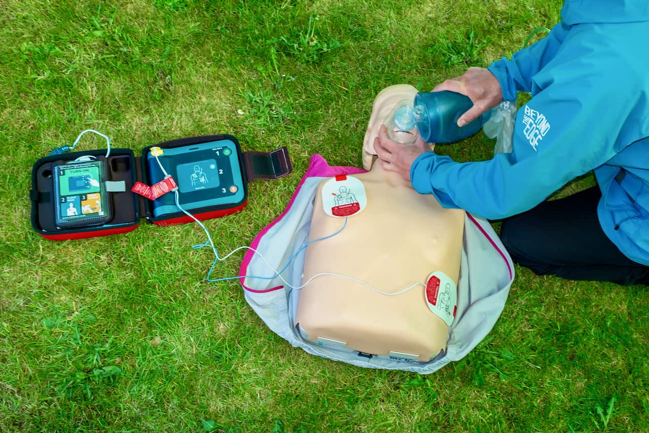 Giving CPR on an outdoor first aid course in the Peak District
