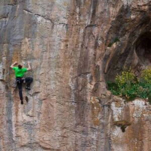 A man sport climbing on a rock face