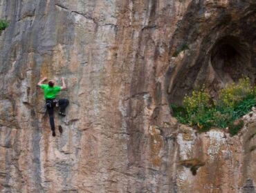 A man sport climbing on a rock face