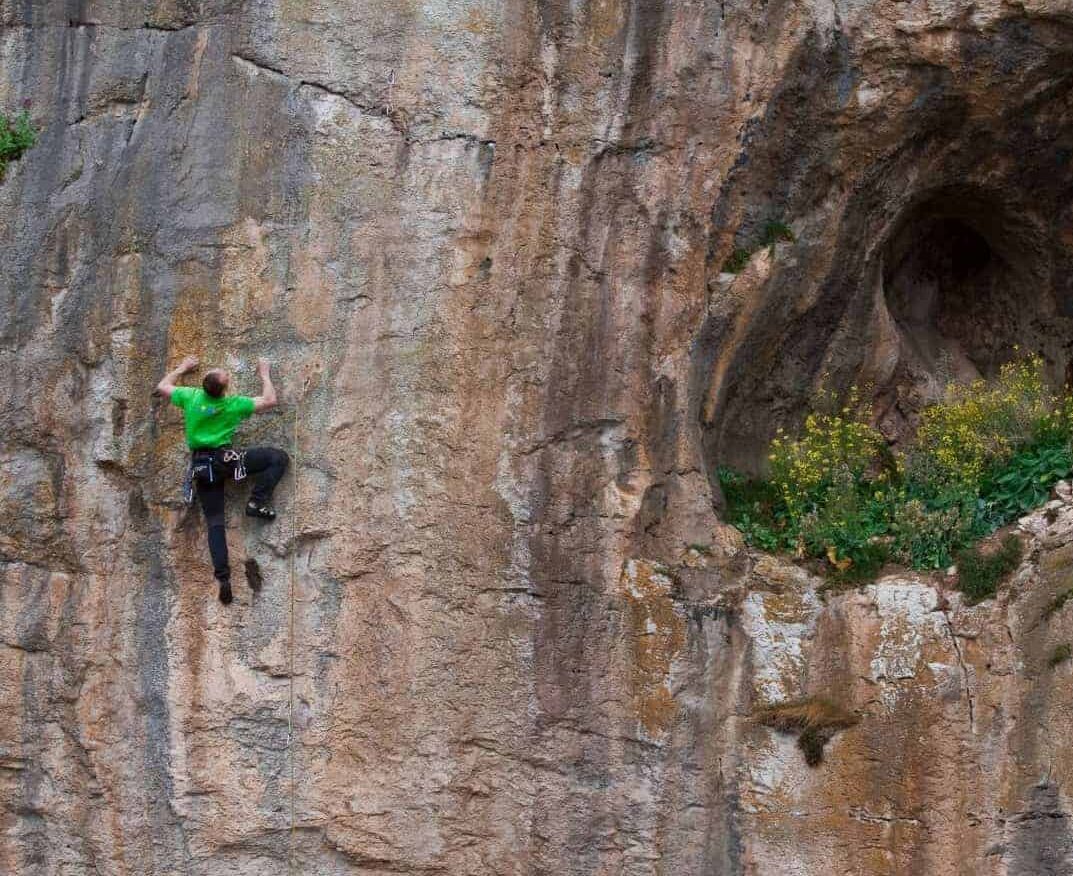 A man sport climbing on a rock face