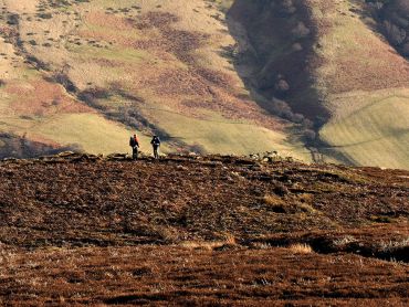 Two people walking on the hills around Edale on a Hill and Moorland Leader course
