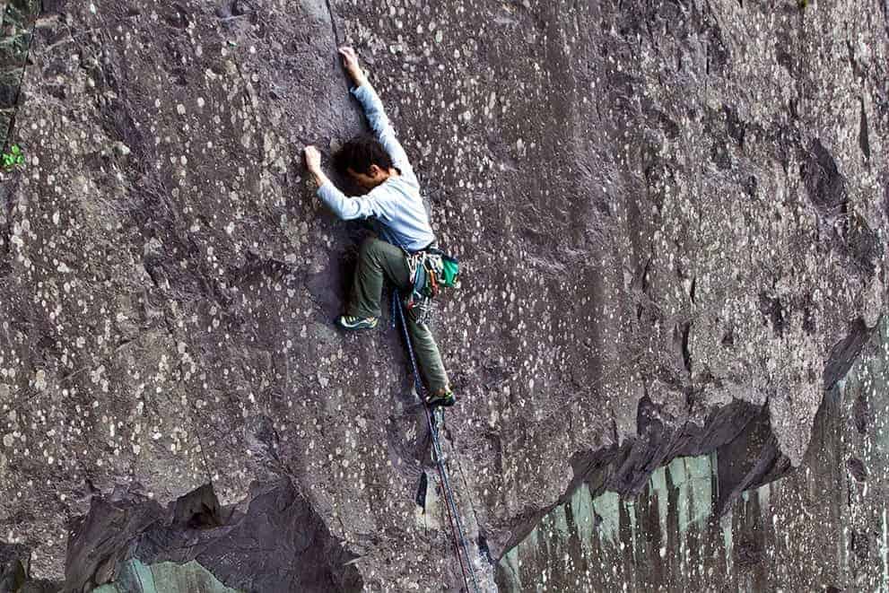 A man rock climbing in the Peak District