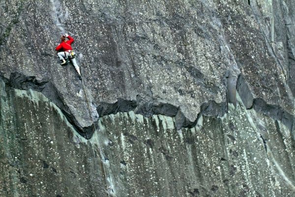 A man on a multi pitch climbing course in the peak District
