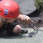 A girl learning to lead climb on Stanage edge in the Peak District