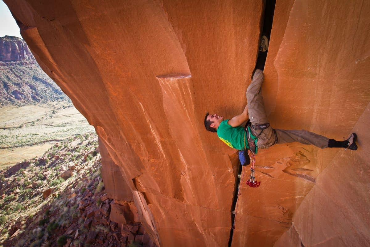 Tom Randall rock climbing on Belly Full of Bad Berries at Indian Creek in the USA. Photo by Alex Ekins