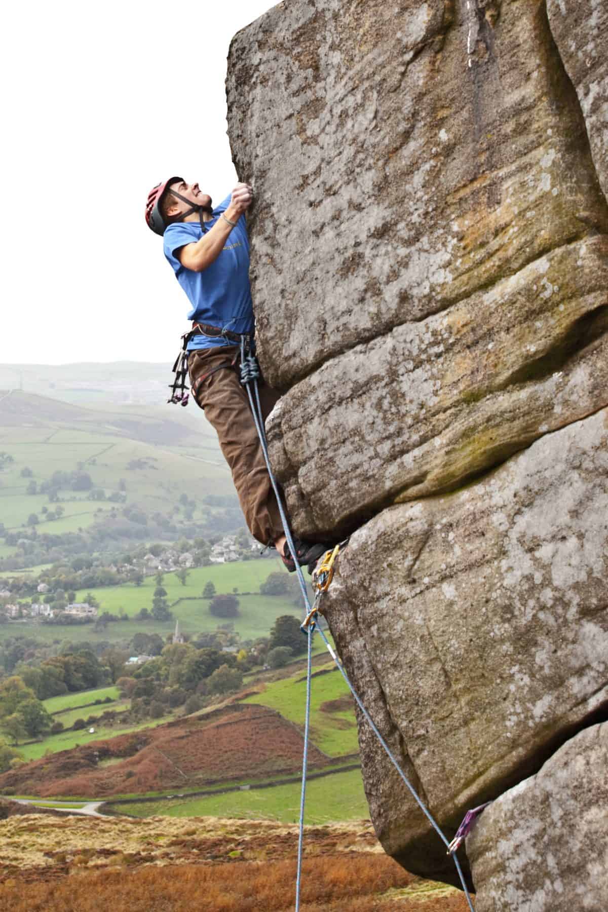 Adam Bailes rock climbing on Higgar Tor in the Peak District
