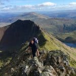 Scrambling along the knife edge of Crib Coch in Eryri (Snowdonia)