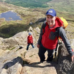 A man scrambles up Moel Siabod in Snowdonia