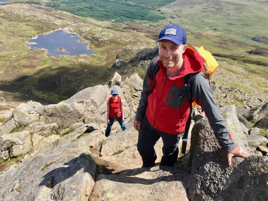 A man scrambles up Moel Siabod win Snowdonia on a mountain skills course.