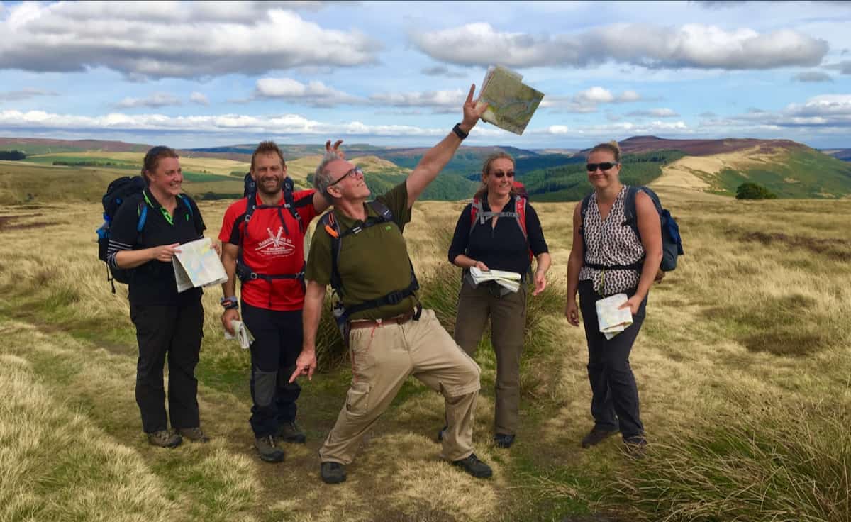 A group of walkers learning to navigate in the Peak District.