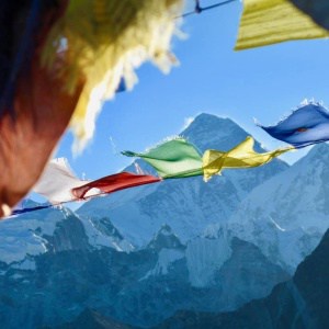 Prayer flags fluttering in front of Everest. Trek from Everest base camp.
