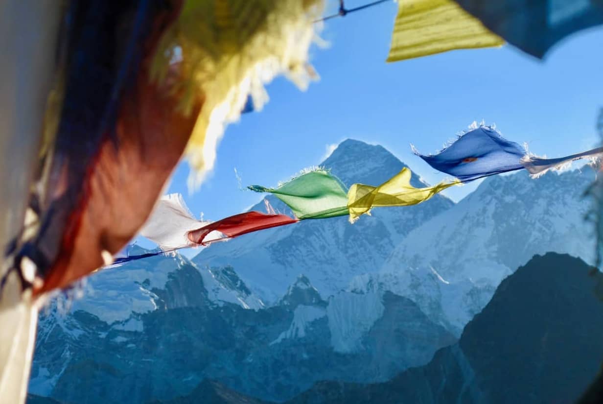 Prayer flags fluttering in front of Everest. Trek from Everest base camp.
