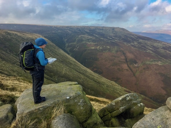 Navigating hillwalker consulting their map