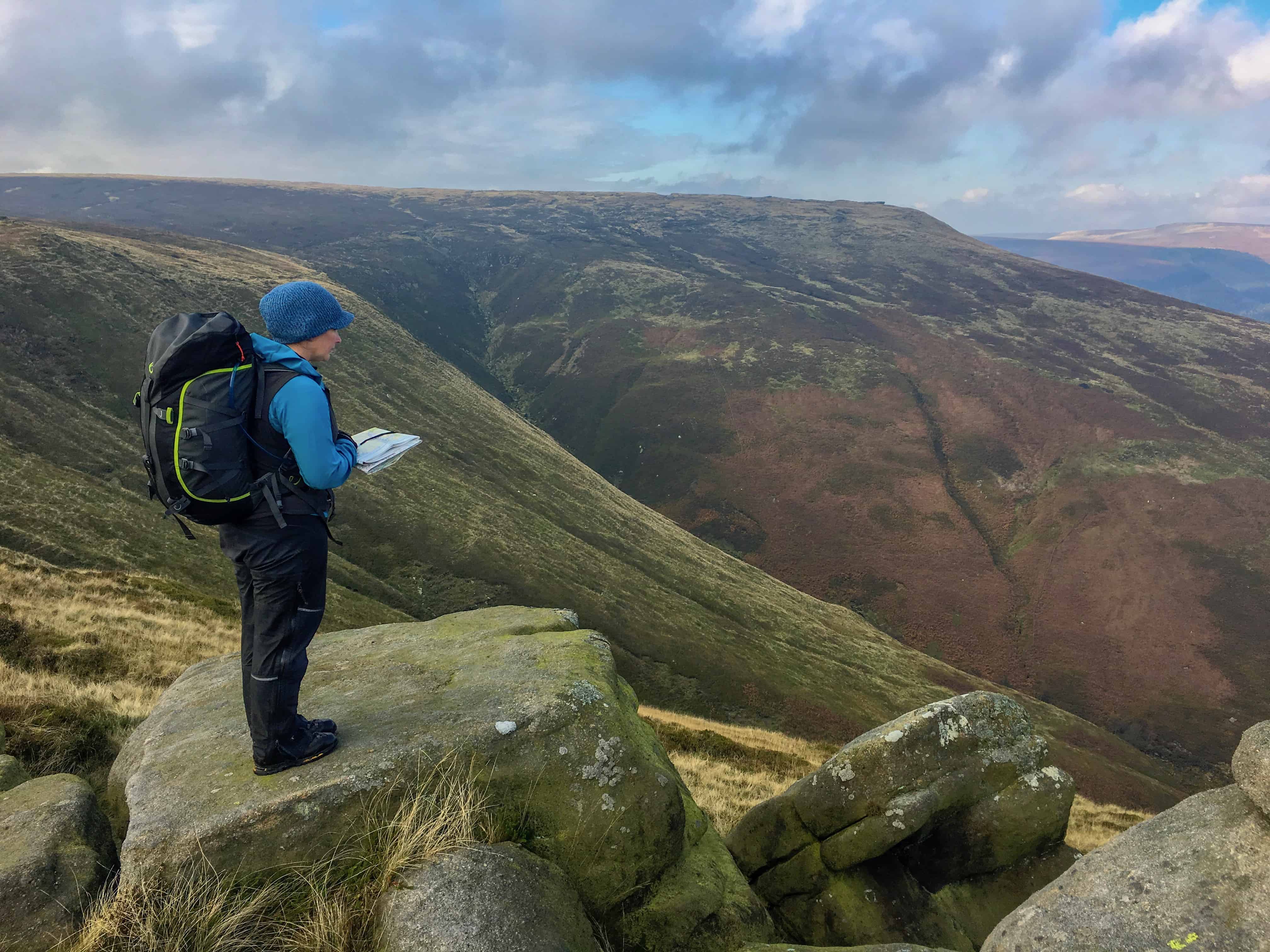 Navigating hillwalker consulting their map