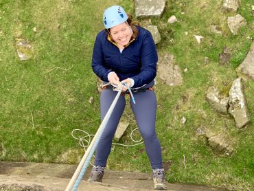 A lady abseiling on a challenge event