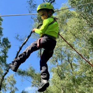 A young boy on a zip line on a Peak District family adventure day