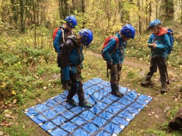 A group of children on an activity camp solving a puzzle
