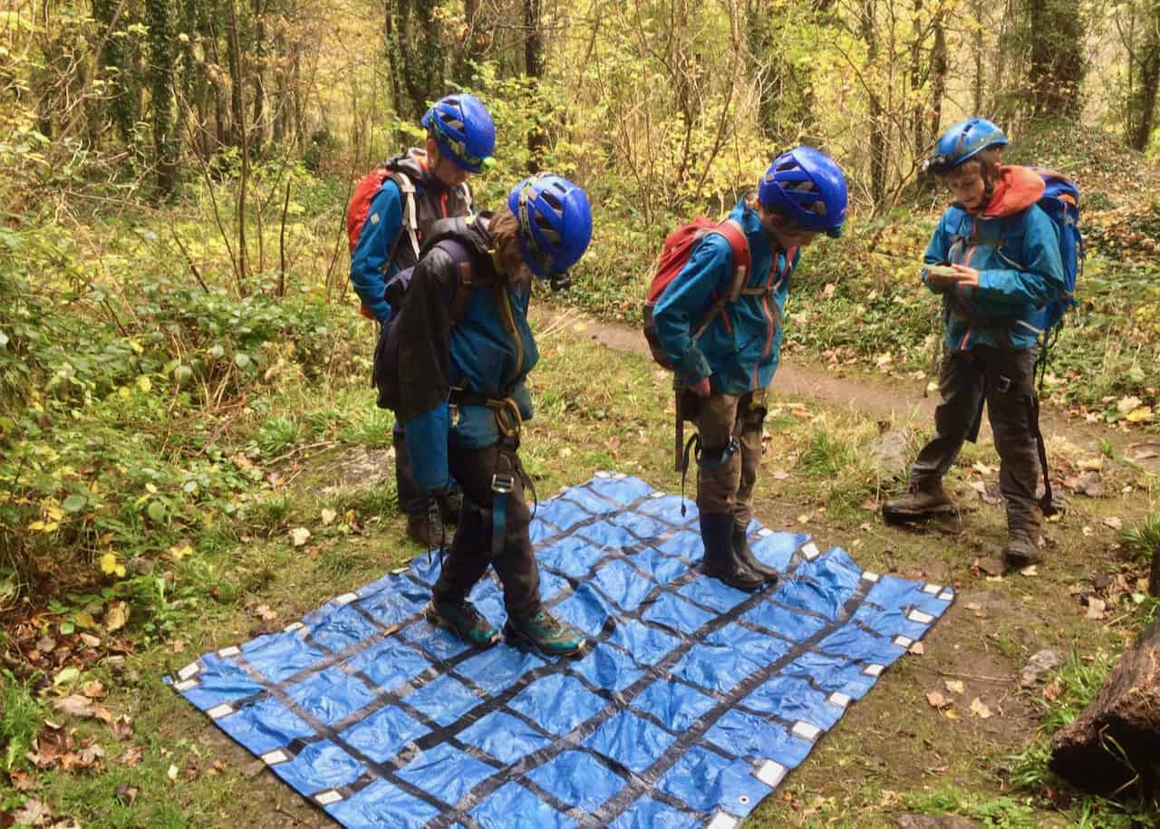 A group of kids play on an adventure camp in the Peak District