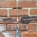 a climbing nut placement in a brick wall