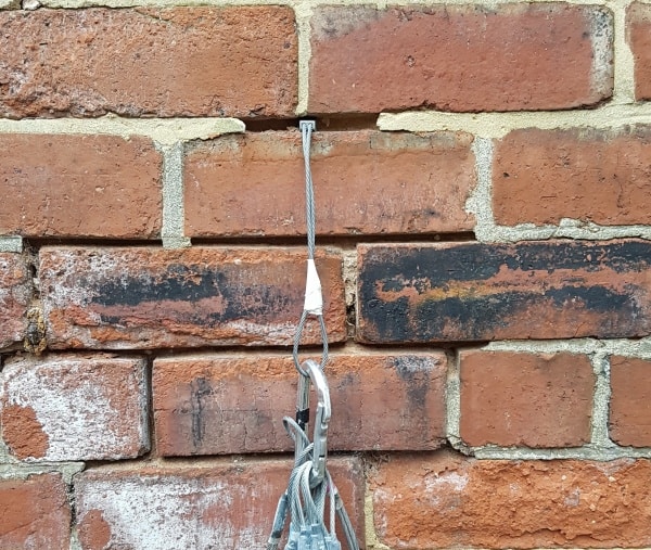 a climbing nut placement in a brick wall