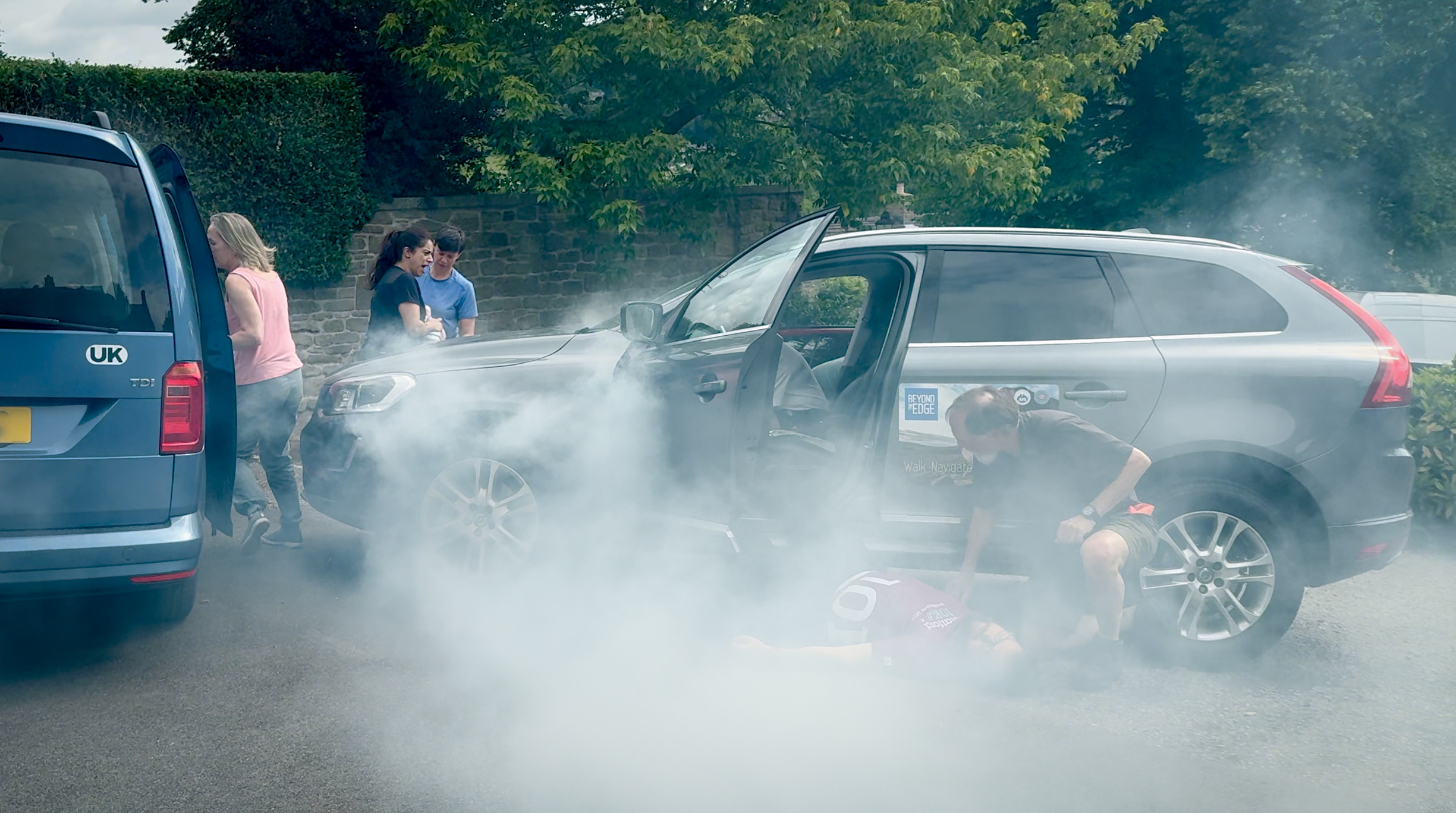 A group practicing advanced first aid in a car crash scenario