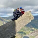 A man and woman on Canon rock on Tryfan on a Mountain Skills course