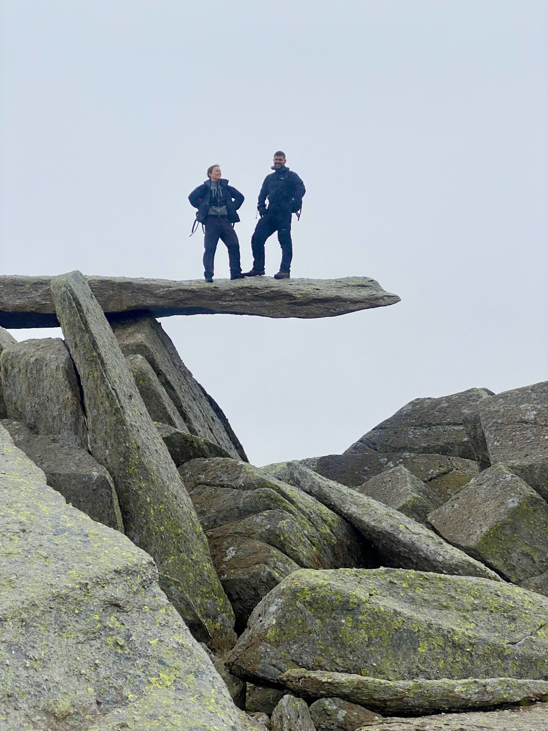 Two people on the Cantilever stone on Glyder Fach on a Mountain Skills course