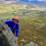 A man scrambling on Tryfan in Snowdonia on an Advanced scrambling course