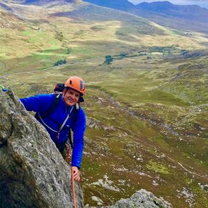 A man scrambling on Tryfan in Snowdonia on an Advanced scrambling course