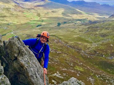 A man scrambling on Tryfan in Snowdonia on an Advanced scrambling course