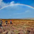 Hill walkers admire a rainbow whilst on a Hillwalking course in the Peak District