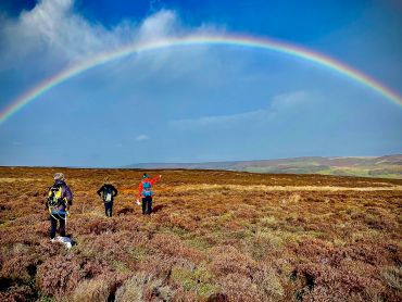 Hill walkers admire a rainbow whilst on a Hillwalking course in the Peak District