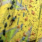 A lady leading a climb on a Climbing Wall development Instructor course.