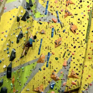 A lady leading a climb on a Climbing Wall development Instructor course.