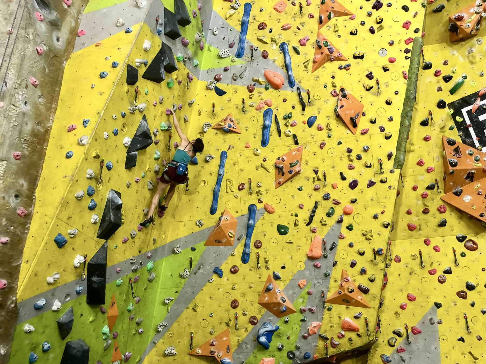 A lady leading a climb on a Climbing Wall development Instructor course.