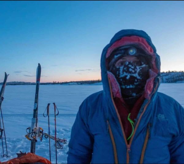 A man wearing the Mountain Equiment Citadel jacket with a snowy background