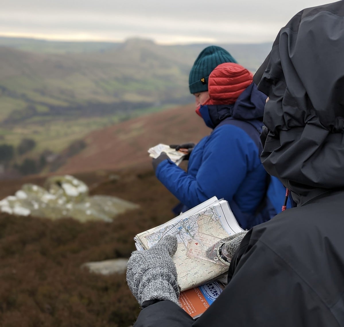A group learning to use a map and compass on a Hill Skills course in the Peak District.