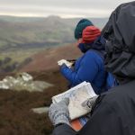 A group learning to use a map and compass on a Hill Skills course in the Peak District.