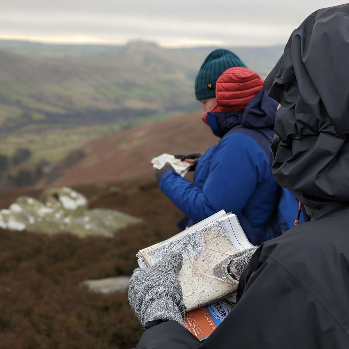 A group learning to use a map and compass on a Hill Skills course in the Peak District.