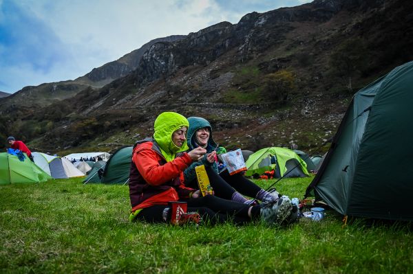 Two women eating a meal at the overnight camp for the OMM