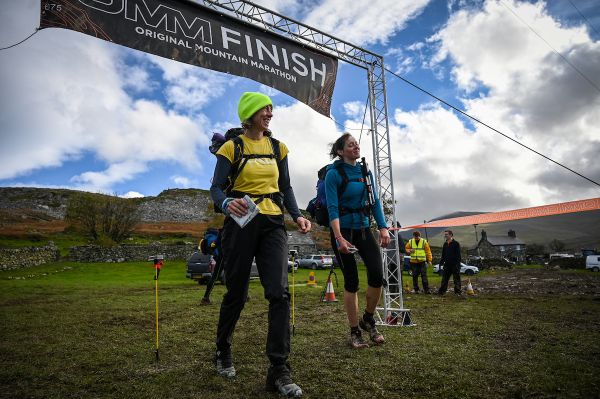 Two women at the finish line for the OMM 2023