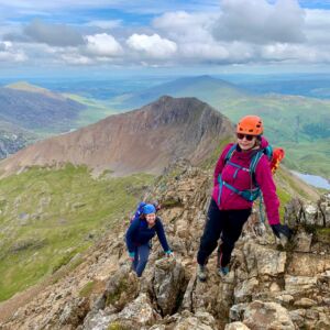 Two women scrambling along Crib Coch