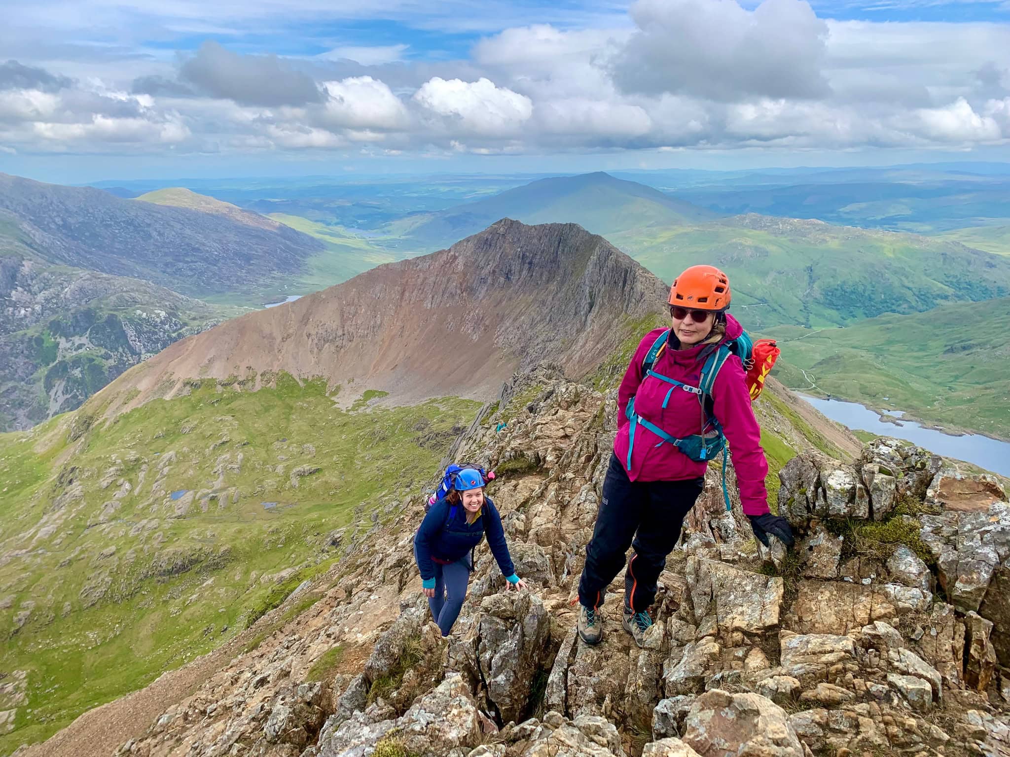 Two women scrambling along Crib Coch