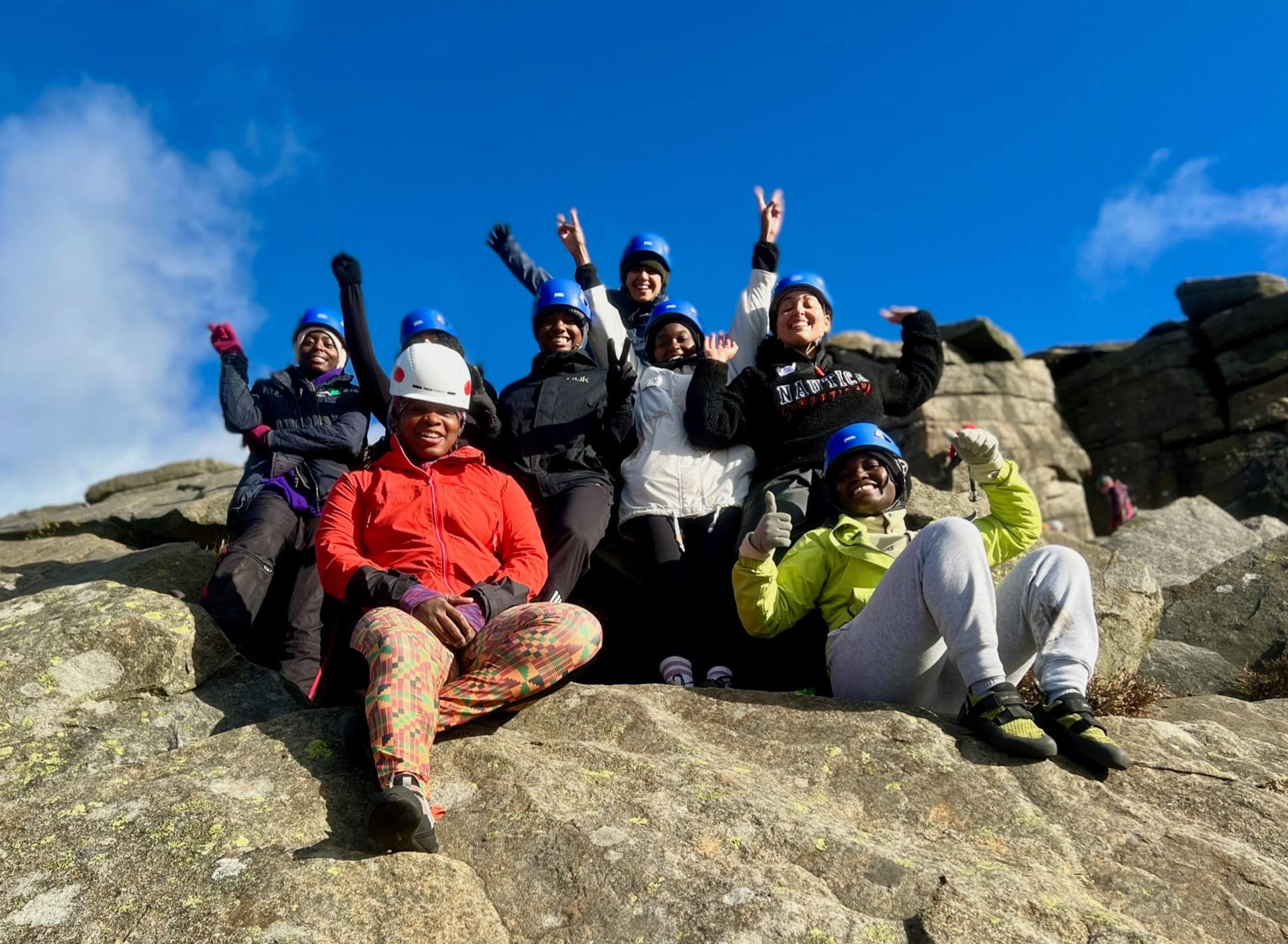 A group of ladies on a rock climbing taster day, sat on rocks in the Burpage valley in the Peak District.