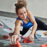 A woman instructing bouldering in a bouldering gym