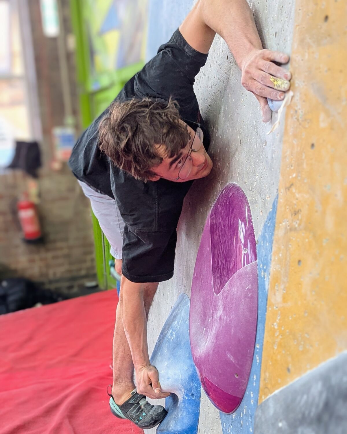 A man bouldering on bouldering wall Instructor training course at The Works, Sheffield.